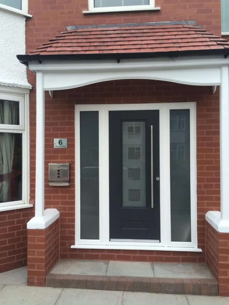 Anthracite composite front door with sidelights under porch