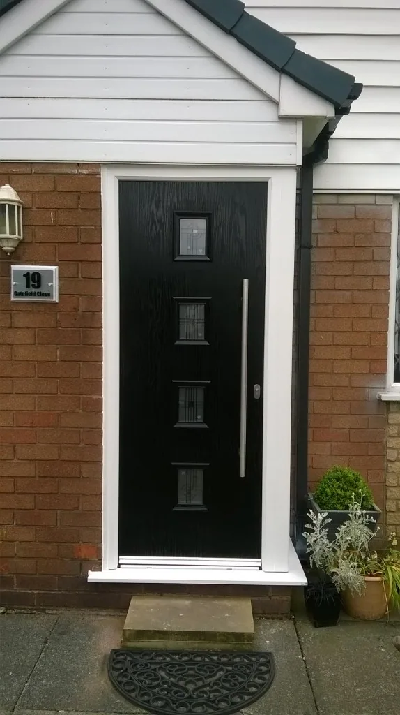 Black composite front door with four square glazed panels