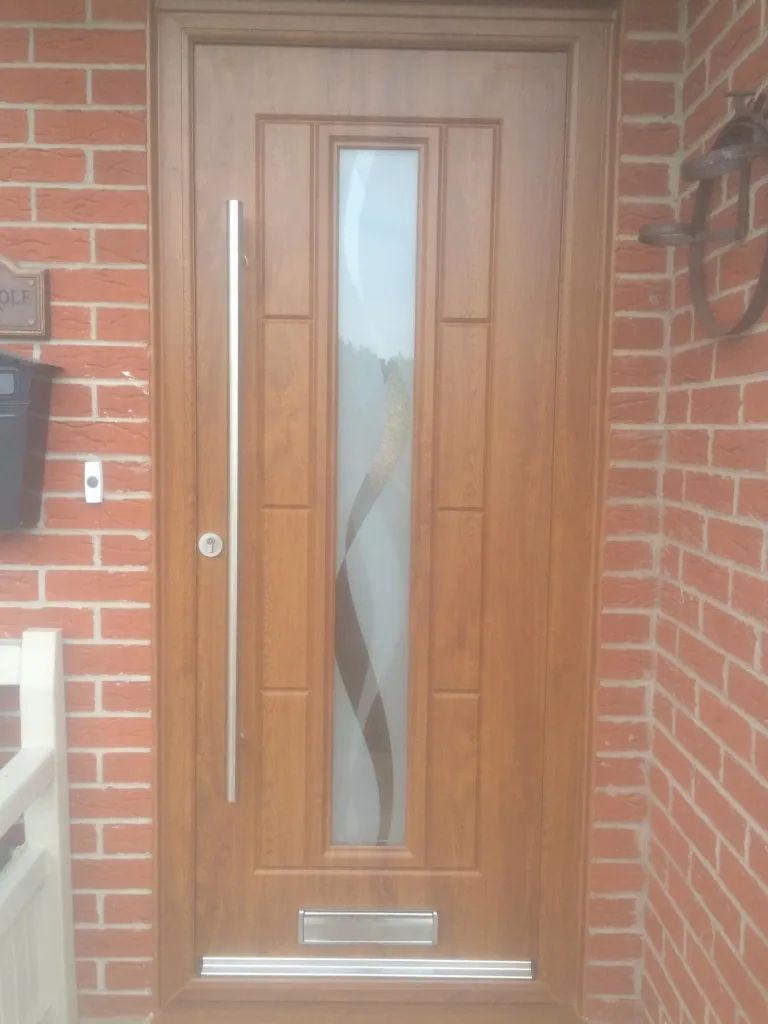 Golden oak composite front door with vertical glazing