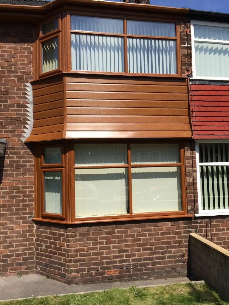Golden oak uPVC double bay windows with cladding