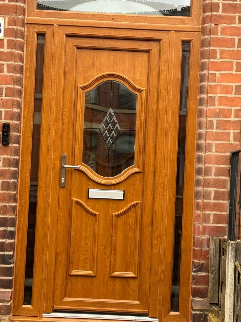 Golden oak composite front door with sidelights and fanlight