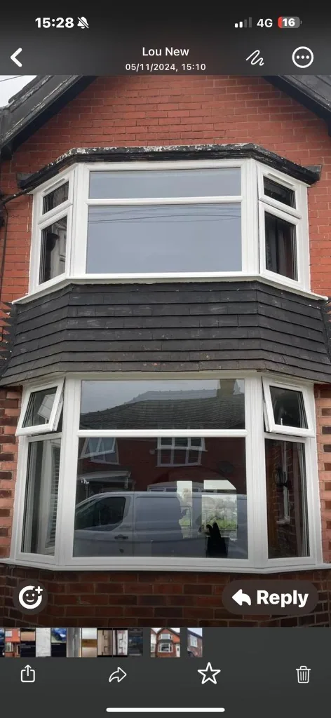 White uPVC double bay windows on red brick house
